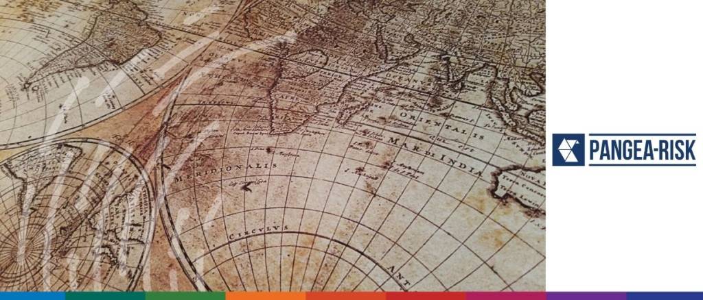 Aerial view of an old map featuring a town with scattered buildings and surrounding landscape.