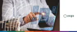 A person using a laptop with digital document icons floating on the screen next to a physical stack of papers, representing Enigio’s self-serve online channel for digital original trade documents for SMEs.