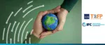 Hands holding a small model of Earth against a green background with logos for ADB, TSCFP, and IFC, representing sustainable supply chain finance.