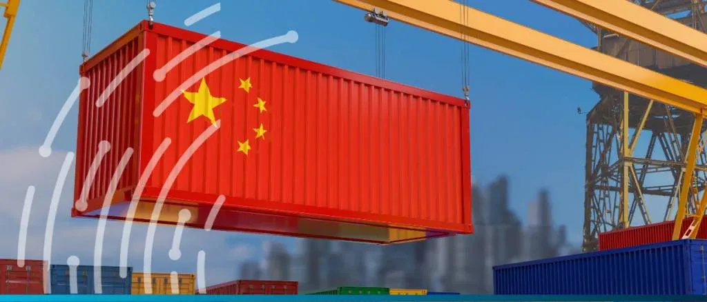 Red shipping container with the China flag being lifted by a crane, representing China's record-high annual trade surplus nearing $1 trillion.