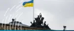 The Ukrainian flag flying over a neoclassical building in Kyiv, symbolizing the EBRD