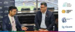A professional interview between a Trade Finance Global representative and the cQuant CEO at Commodity Trading Week, discussing the race to renewables and the future of energy trading.