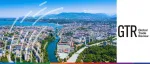 Daytime aerial view of Geneva, Switzerland, featuring the Rhone River flowing into Lake Geneva and the Jet d