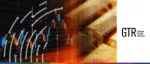 Global Trade Review (GTR) logo beside a high-tech visualization of gold bullion bars overlaid with glowing financial candlestick charts and trade data trends.
