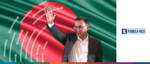 Businessman gesturing in front of Bangladesh flag, highlighting trade instability issues.