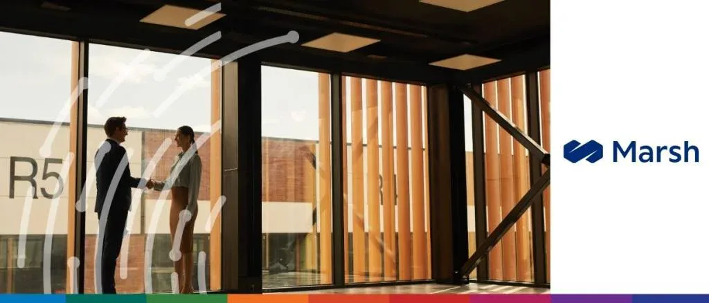Two professionals shaking hands in a modern office with large windows, illustrating leasing as a strategic path to business liquidity, featuring the Marsh logo.