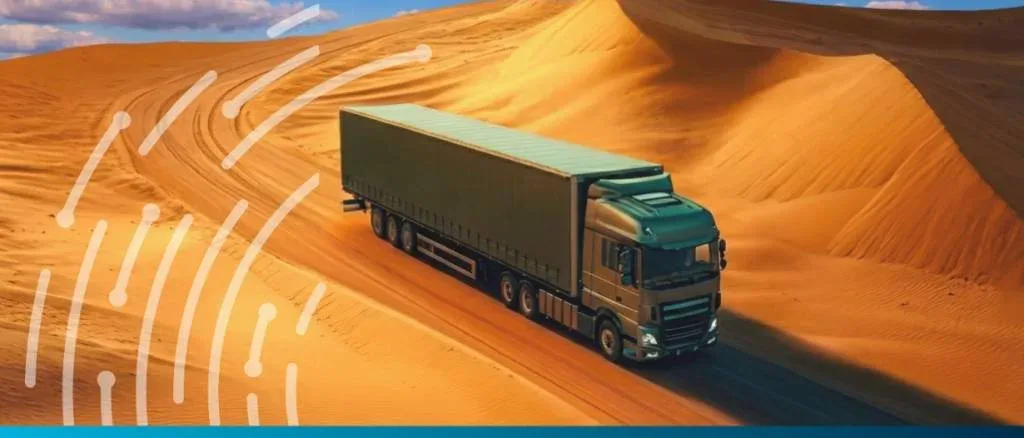 A cargo truck driving through a desert landscape, illustrating a Trade Finance Global feature on a UNCTAD report regarding the global South’s marginalization in trade finance.
