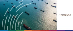 Aerial view of multiple cargo ships at sea, illustrating global shipping and trade risks.