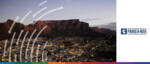 Panoramic view of a city with mountains at sunset, highlighting Asian and African investment regions.