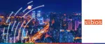 Nighttime aerial view of the illuminated Beijing skyline and financial district featuring the CITIC Tower (China Zun) under a full moon for Sibos 2024.