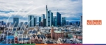 Panoramic view of the Frankfurt skyline and the Commerzbank Tower under a cloudy sky, featured as the location for the Sibos financial services conference.