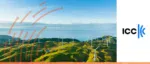 An aerial view of a wind farm on rolling green hills by the ocean with the ICC logo, representing the International Chamber of Commerce