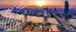A vibrant, high-resolution sunset over the Bangkok skyline and Chao Phraya River, featuring a realistic cityscape with modern skyscrapers, traditional Thai architecture, and a stylised white digital connectivity graphic overlay.