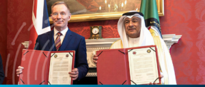 Business leaders signing partnership agreement in formal setting.