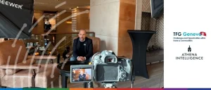 Jonas Rey sits behind a table with a black tablecloth, facing a camera in a setting designed to discuss financial crime in trade finance. A light is positioned to the left, setting the stage for a discussion on detecting trade finance fraud