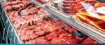 Fresh meat products displayed in a supermarket refrigerated case, highlighting import trends and foo.