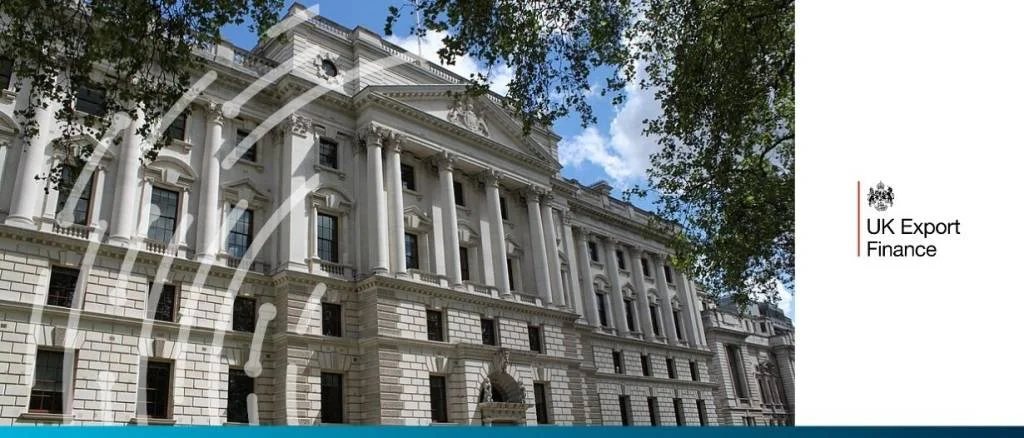 The grand white stone facade of the UK HM Treasury building in London under a blue sky.
