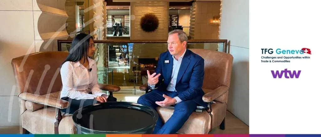 Video interview at TFG Geneva 2025 titled "Commodity risk in 2026: The new era of optionality," featuring Deepesh Patel and a WTW expert discussing global risk management.
