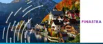 A picturesque lakeside village in the European Alps with colorful houses and a church steeple, featuring the Finastra logo to represent global financial software solutions.