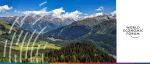 Panoramic daytime view of the snow-capped Swiss Alps and lush green valleys in Davos for the World Economic Forum (WEF) Annual Meeting.