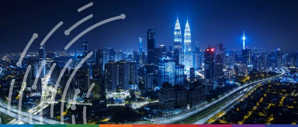 Panoramic view of the Kuala Lumpur skyline featuring the Petronas Twin Towers, symbolizing Malaysia's economic resilience and 2026 growth trajectory in global trade and finance.